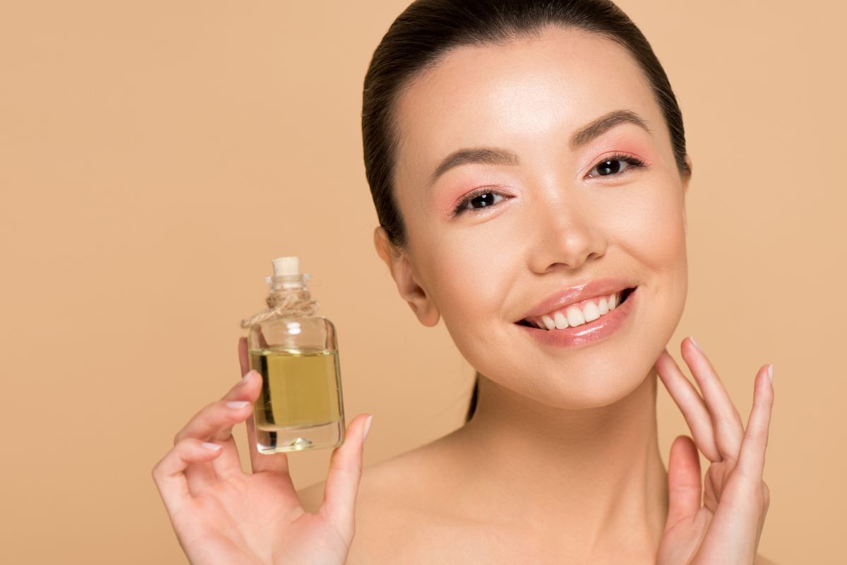 Korean woman holds up scent bottle